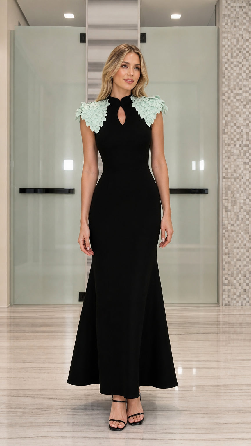 Front view of black mermaid evening dress with mint green petal shoulder embellishments
