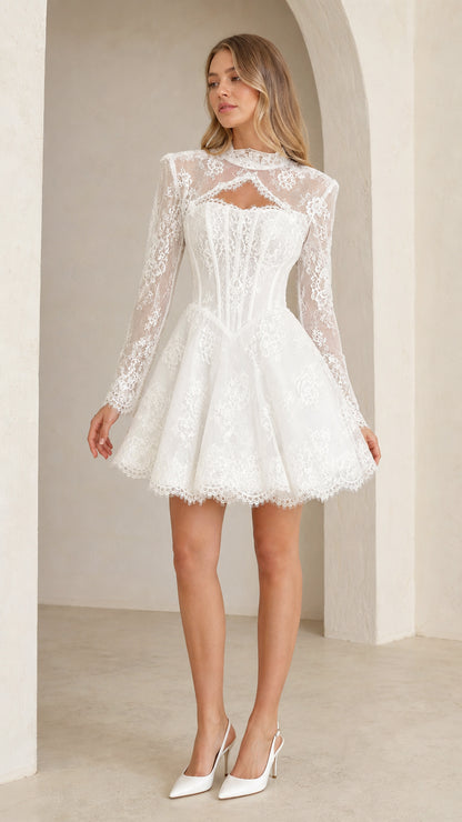Front view of model wearing white floral lace cutout corset mini dress with long sleeves
