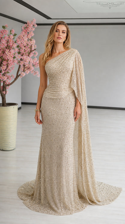 Front view of model wearing champagne one-shoulder sequin evening gown with cape drape