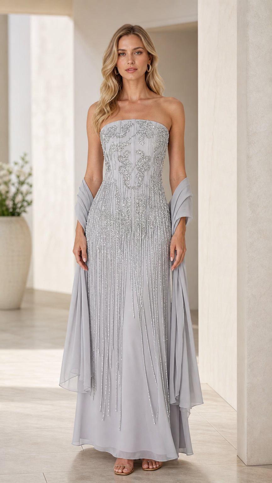 Front view of model wearing dusty blue strapless embellished evening gown with matching shawl