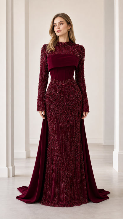 Front view of model wearing burgundy long sleeve beaded evening gown with draped train