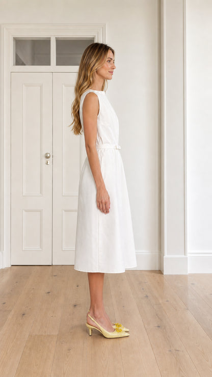 Side profile of woman wearing white sleeveless pleated A-line midi dress