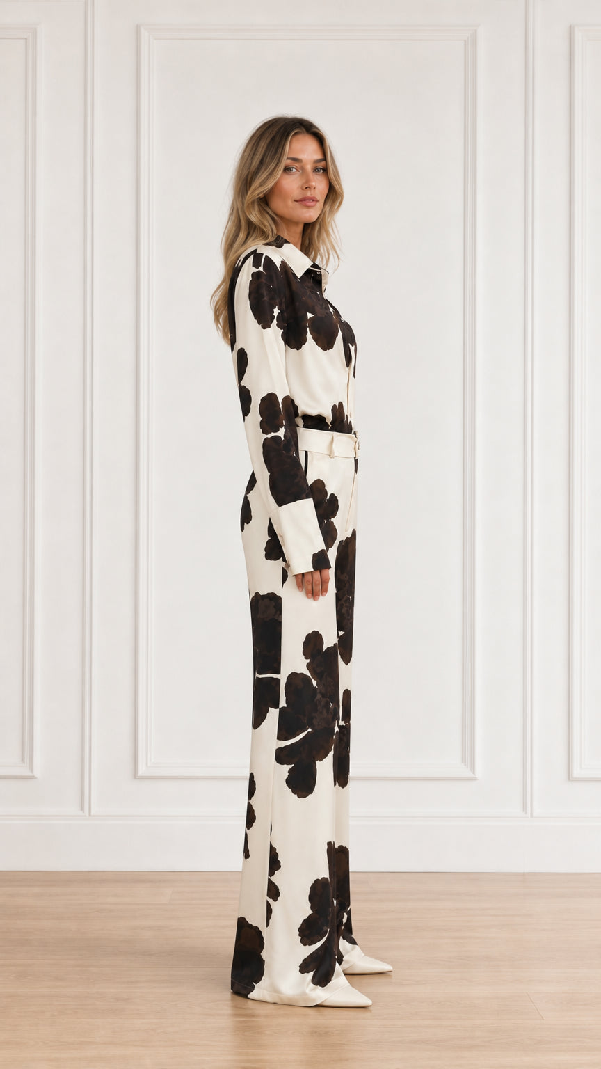 Side view of woman wearing matching floral print pant set in cream