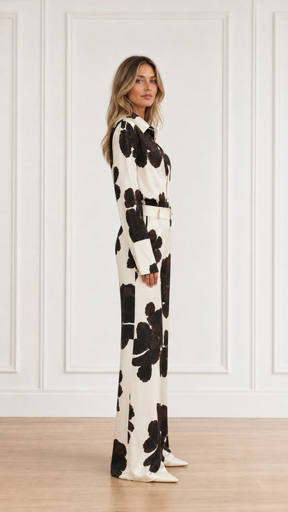 Side view of woman wearing matching floral print pant set in cream