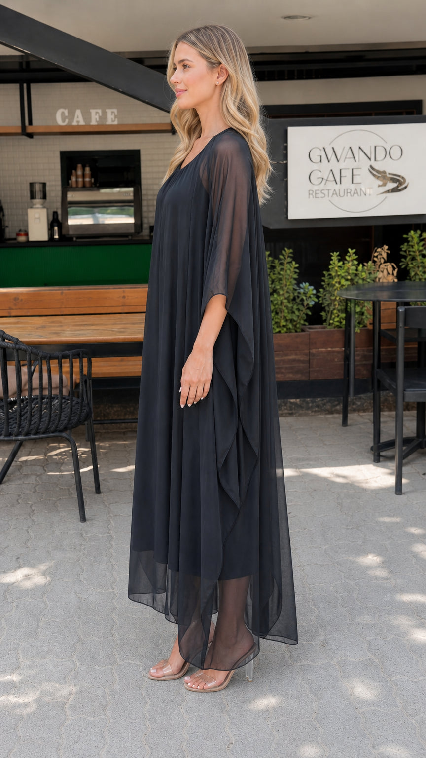 Model wearing black chiffon kaftan maxi dress side view showing draped sleeves