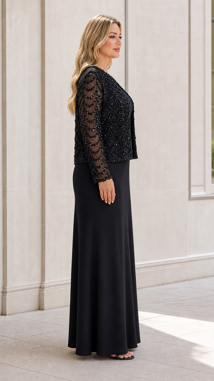 Side profile view of black evening gown and sequin jacket set