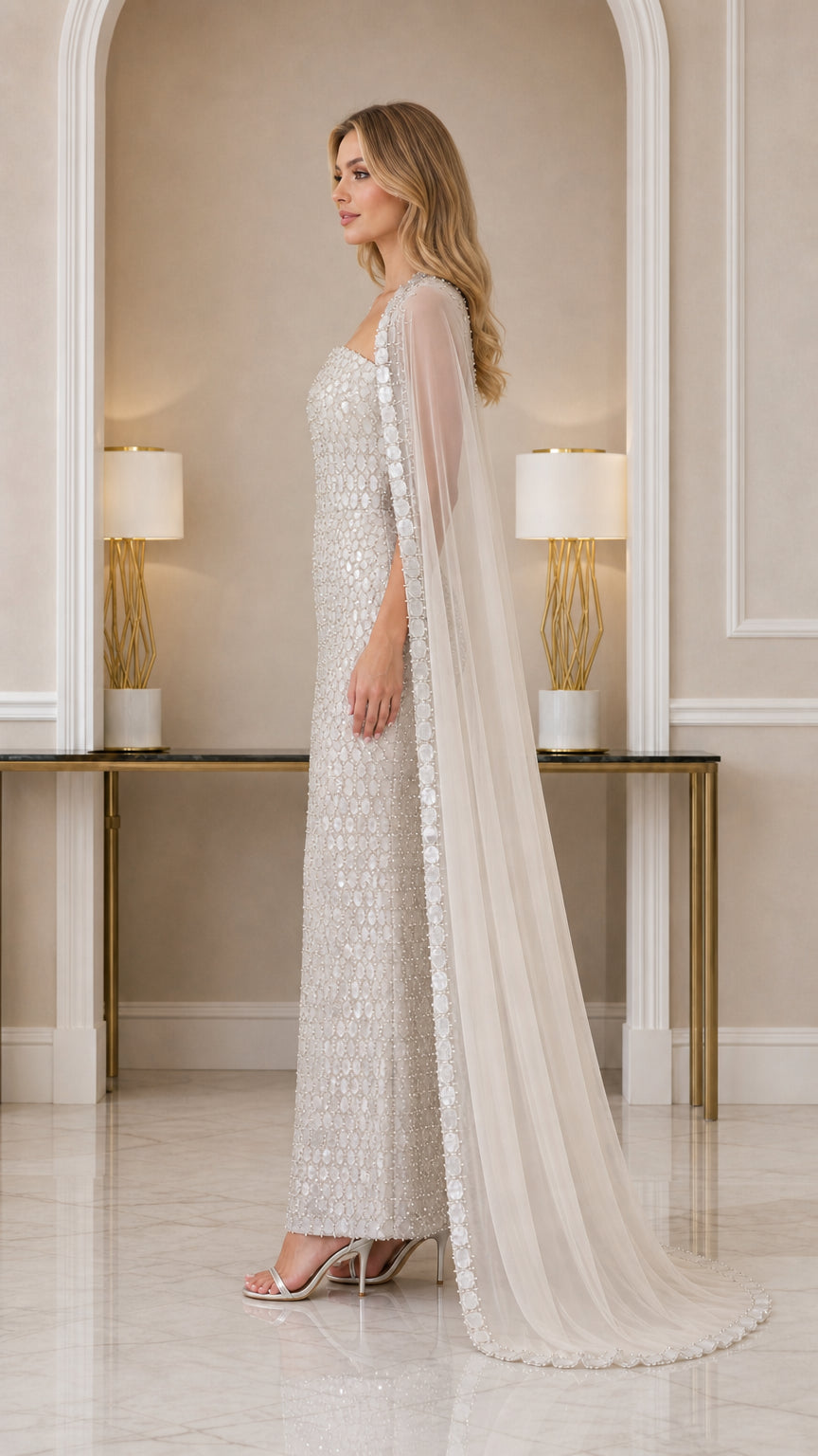 Side profile of Champagne beaded evening gown and flowing sheer cape