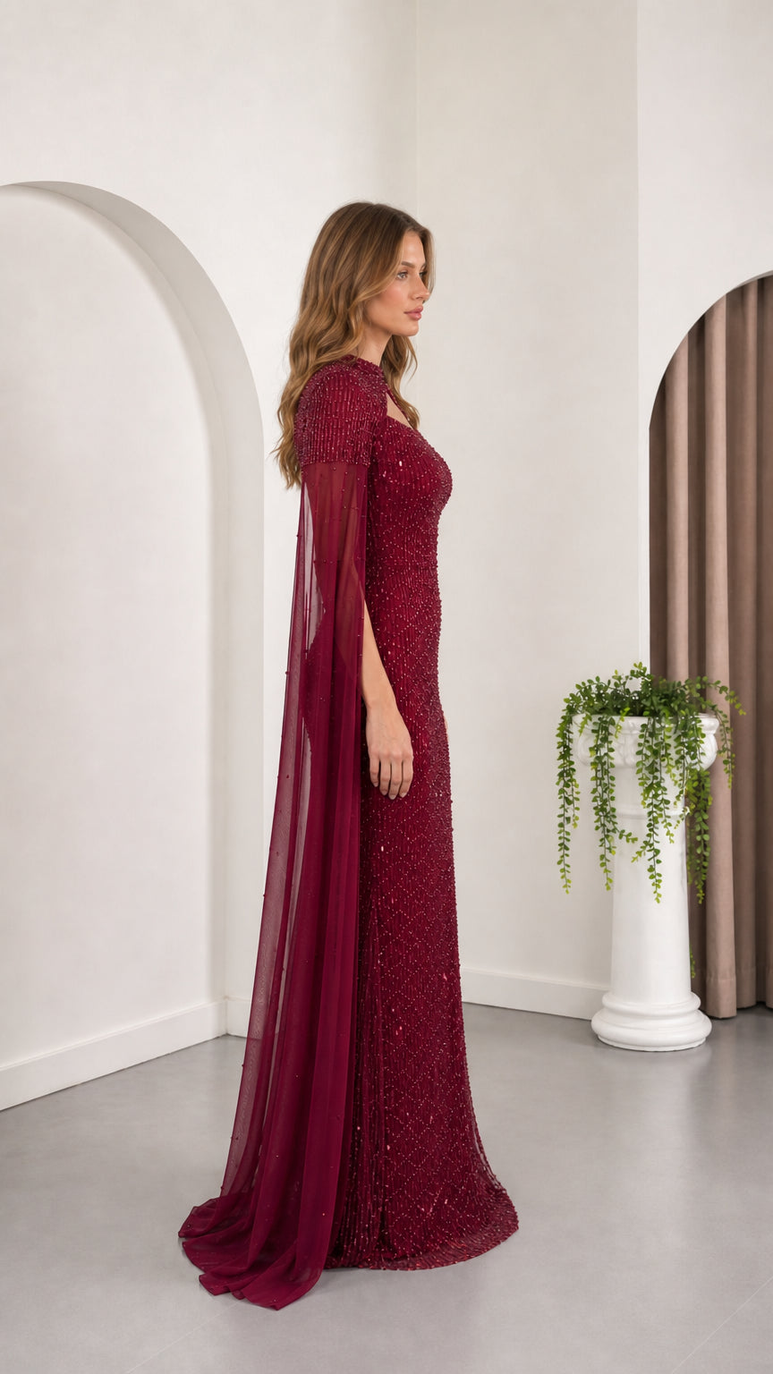 Burgundy fitted sequin formal gown shown from the side