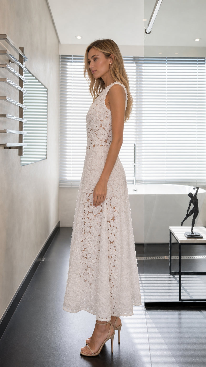 Side profile view of model wearing white sleeveless 3D floral lace maxi dress