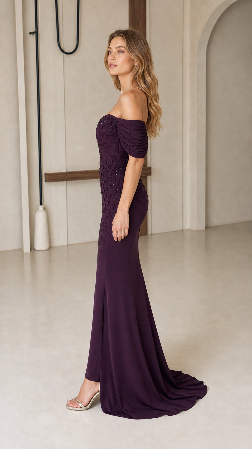 Side profile view of dark plum beaded mermaid formal evening dress