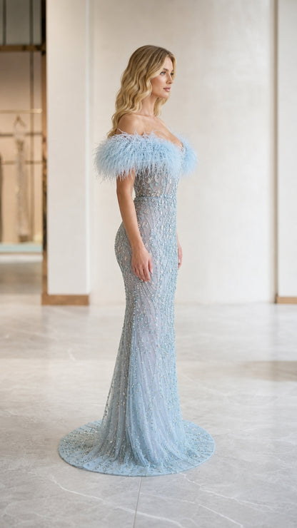 Side profile of light blue mermaid formal dress with sweep train