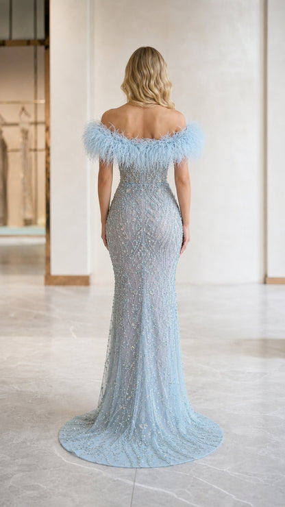 Back view of light blue embellished evening gown with train