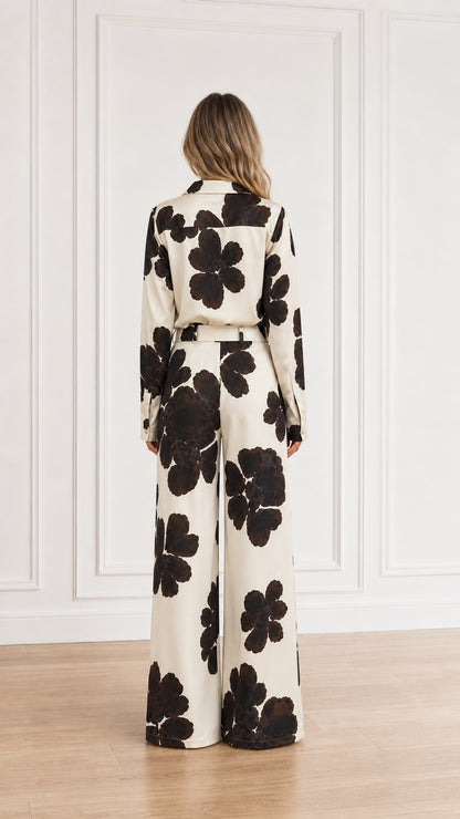 Back view of floral print long sleeve shirt and wide-leg trousers set in cream