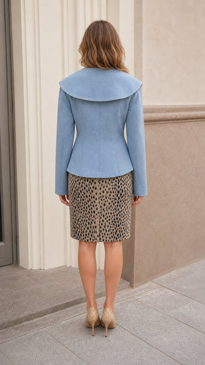 Back view of woman wearing sky blue jacket showing dramatic wide shawl collar back cape detail