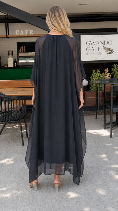 Model wearing black chiffon kaftan maxi dress back view