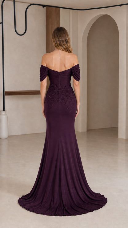 Back view of plum off-the-shoulder gown showcasing the elegant fit and trailing skirt