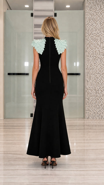 Back view of black floor-length gown showing rear zipper closure and petal shoulders