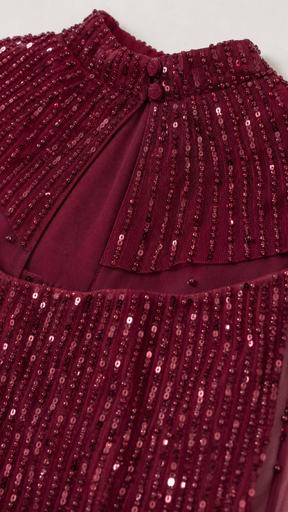 Close-up of burgundy sequin embellishment and neckline detail