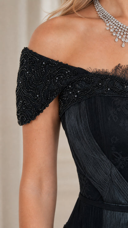 Close-up detail of beaded off-the-shoulder sleeve and delicate lace neckline trim