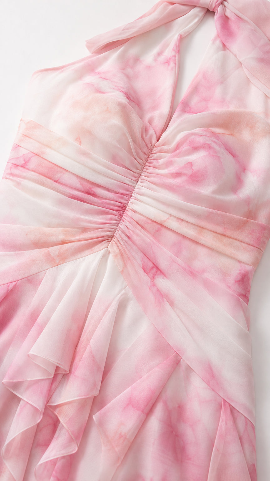 Close-up detail of the ruched bodice and cascading ruffles on the pink printed dress