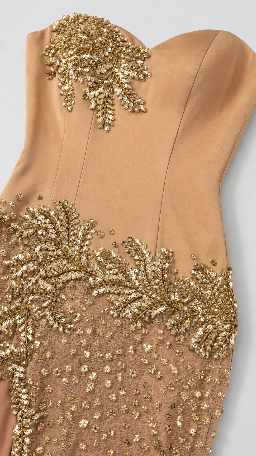 Close-up detail of intricate gold leaf beadwork on champagne satin bodice