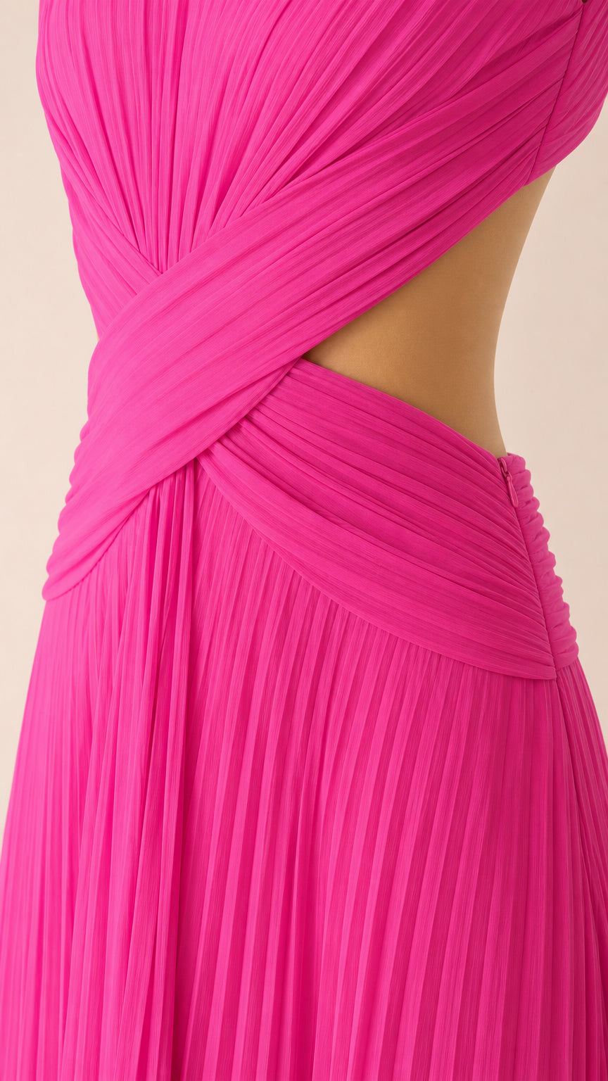 Close-up of waist cutout and criss-cross pleated detailing on hot pink gown