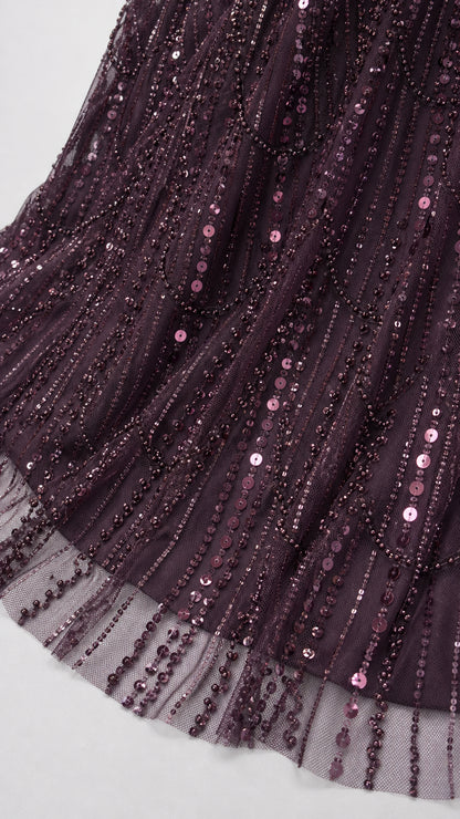 Close-up detail of sheer mesh hem with vertical plum sequin and bead embellishments