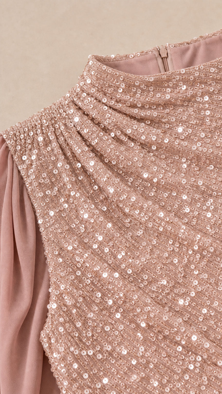 Close-up detail of gathered mock neckline and sparkling sequin texture