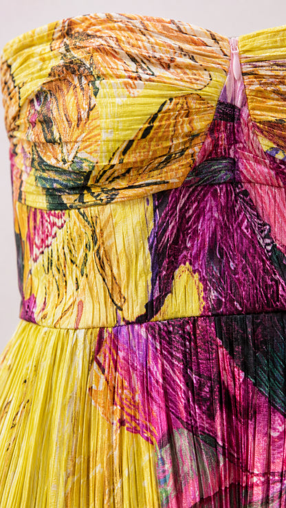Close-up detail of textured pleating and bodice on abstract print dress