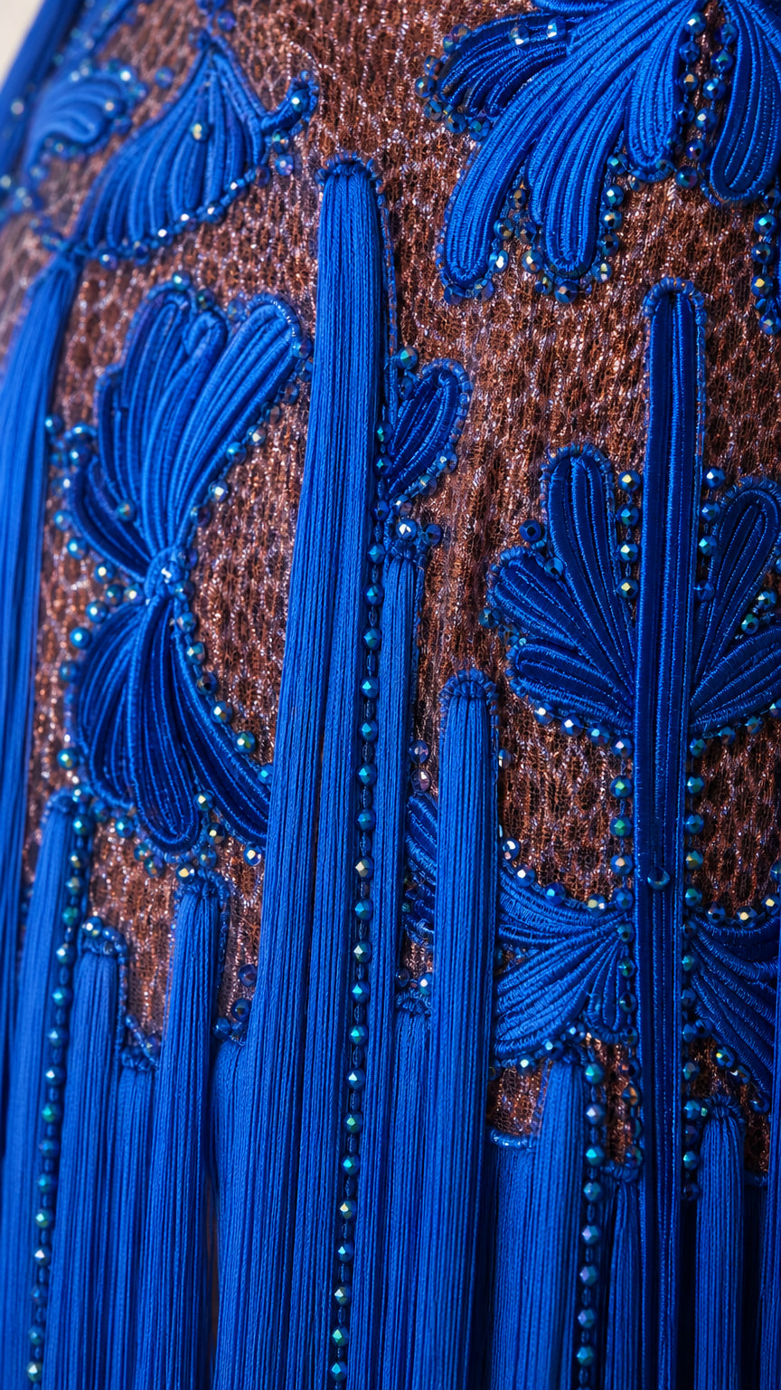 Close-up detail of Royal Blue cord embroidery, bead accents, and tassel fringe