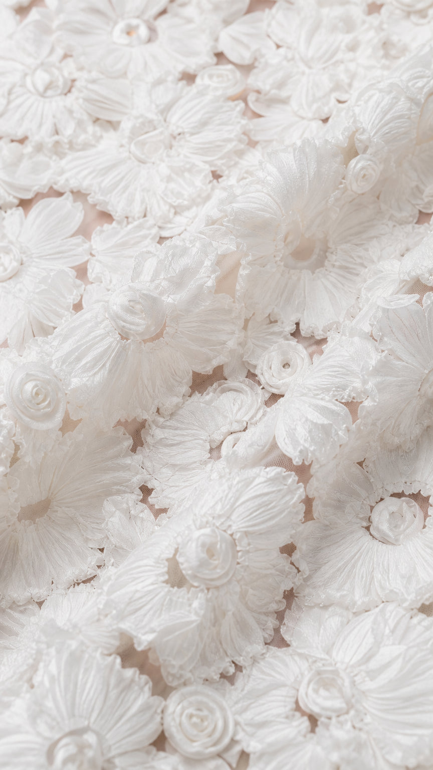 Close-up detail of textured 3D floral lace embroidery fabric