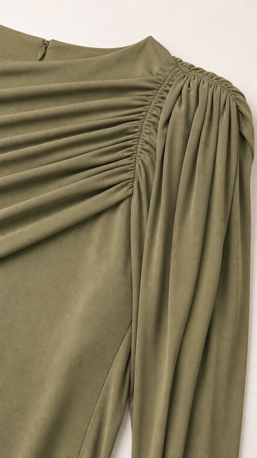 Close-up detail of gathered shoulder and neckline ruching on olive green fabric
