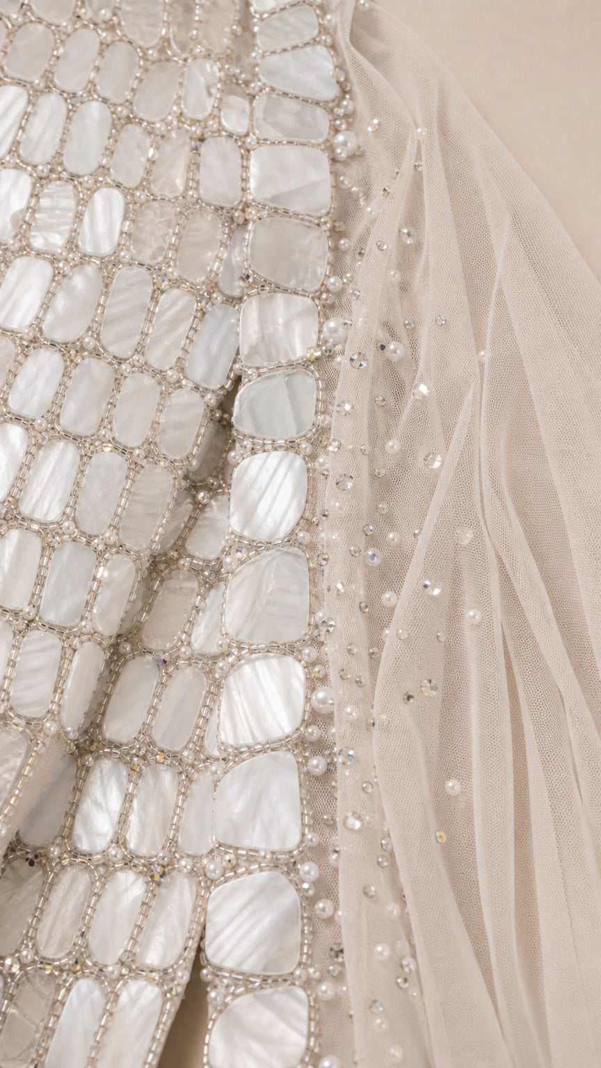 Close-up detail of geometric beadwork and paillette embellishment