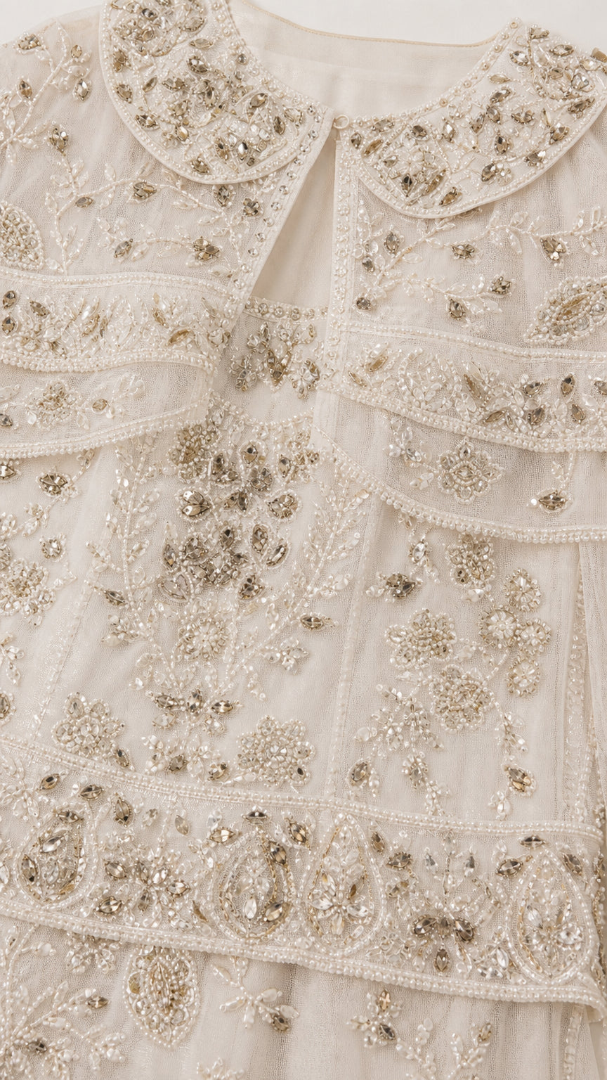 Close-up detail of intricate floral beadwork and sequin embellishments