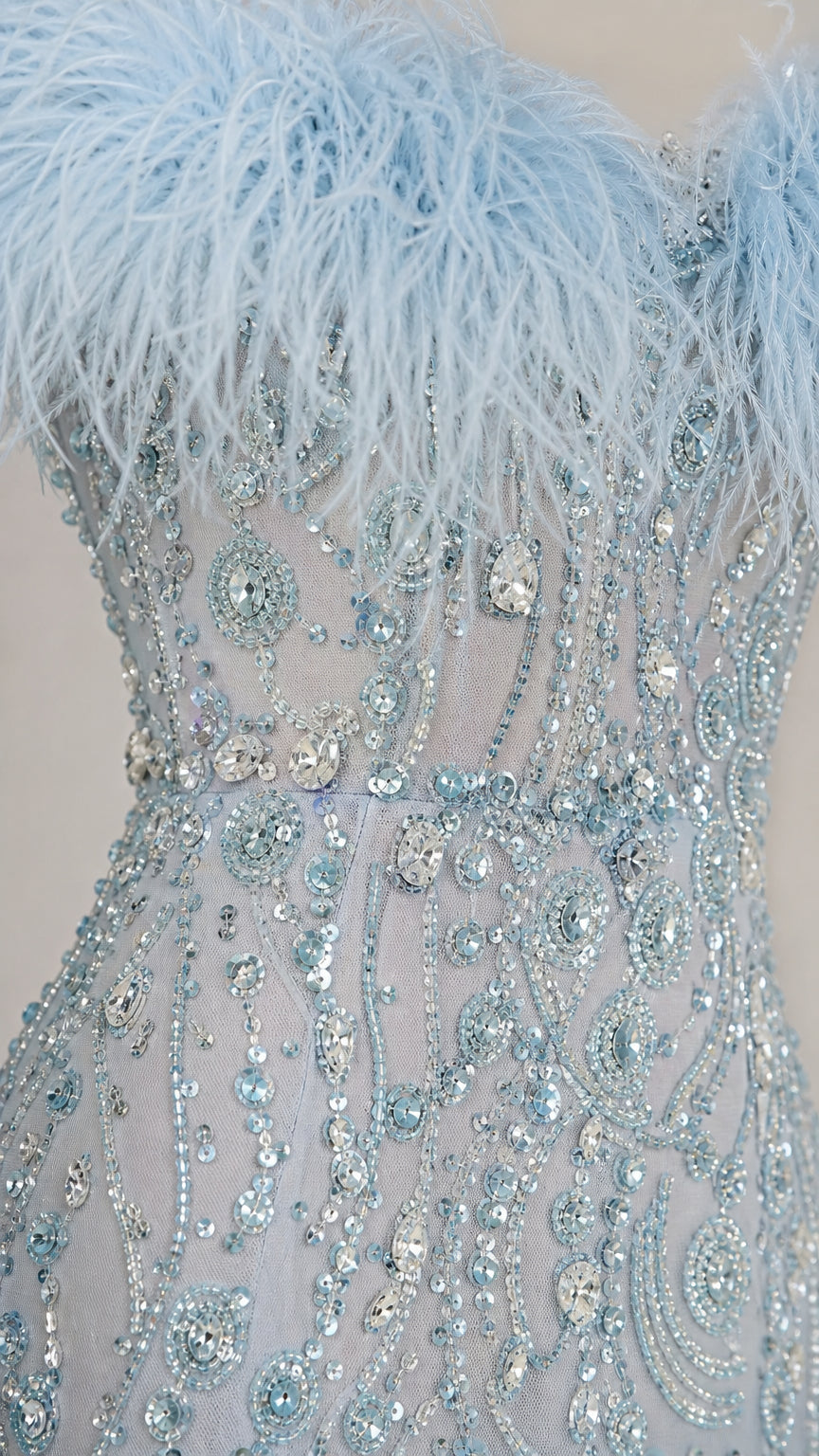 Close-up detail of light blue feather neckline and intricate sequin beading