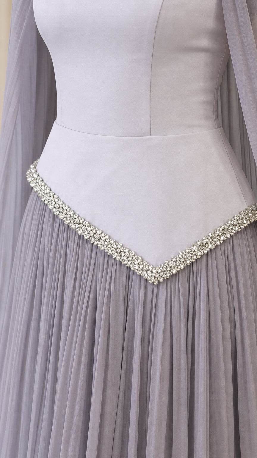 Close-up detail of rhinestone trimmed pointed basque waist and pleated chiffon skirt