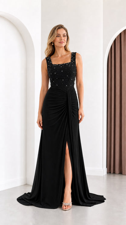 Full length front view of black beaded square neck evening gown with side slit