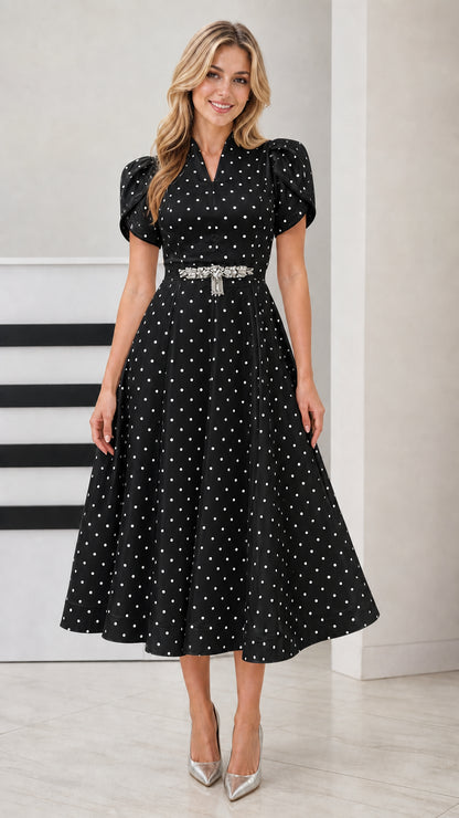 Front view of woman wearing Black polka dot V-neck flared midi dress