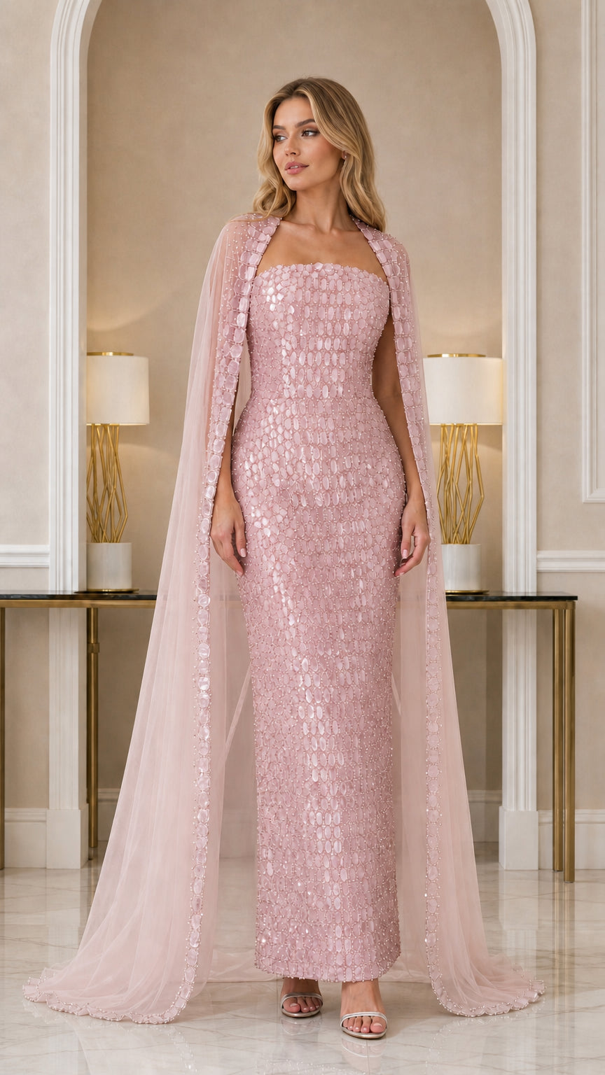 Model wearing Blush Pink embellished formal dress with matching sheer cape