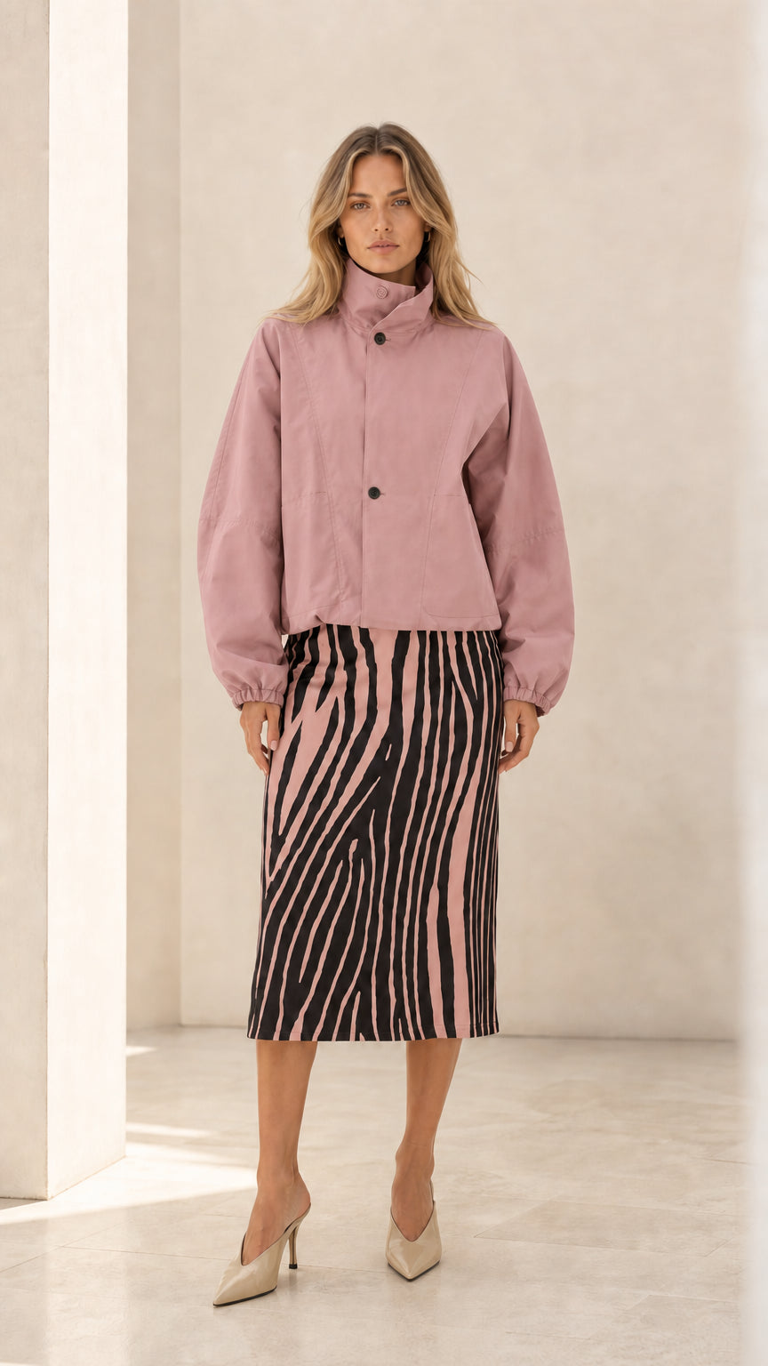 Front view of woman wearing dusty pink cropped stand collar jacket