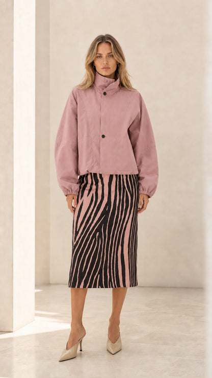Front view of woman wearing dusty pink cropped stand collar jacket