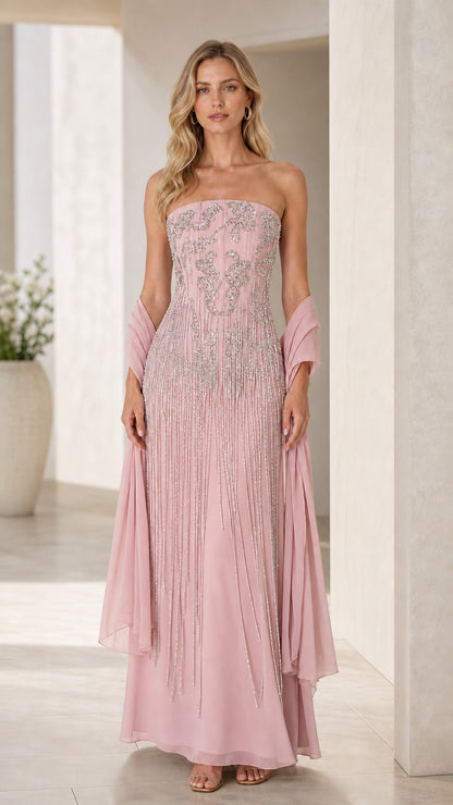 Model wearing blush pink strapless beaded maxi gown with matching pink wrap