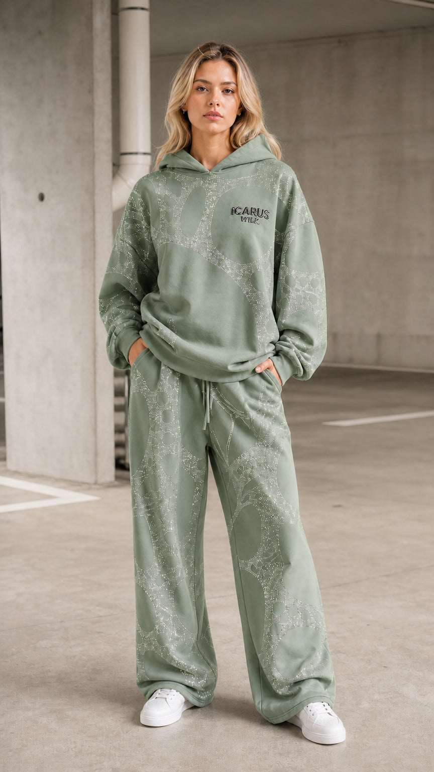 Front view of model wearing sage green rhinestone hoodie and pants set