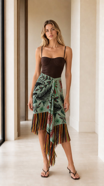 Model wearing sage green tropical print wrap skirt