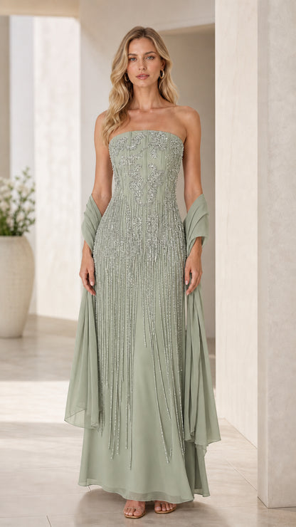 Model wearing sage green strapless formal gown with beaded details and shawl