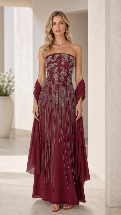 Model wearing burgundy wine strapless evening gown with embellished bodice and shawl