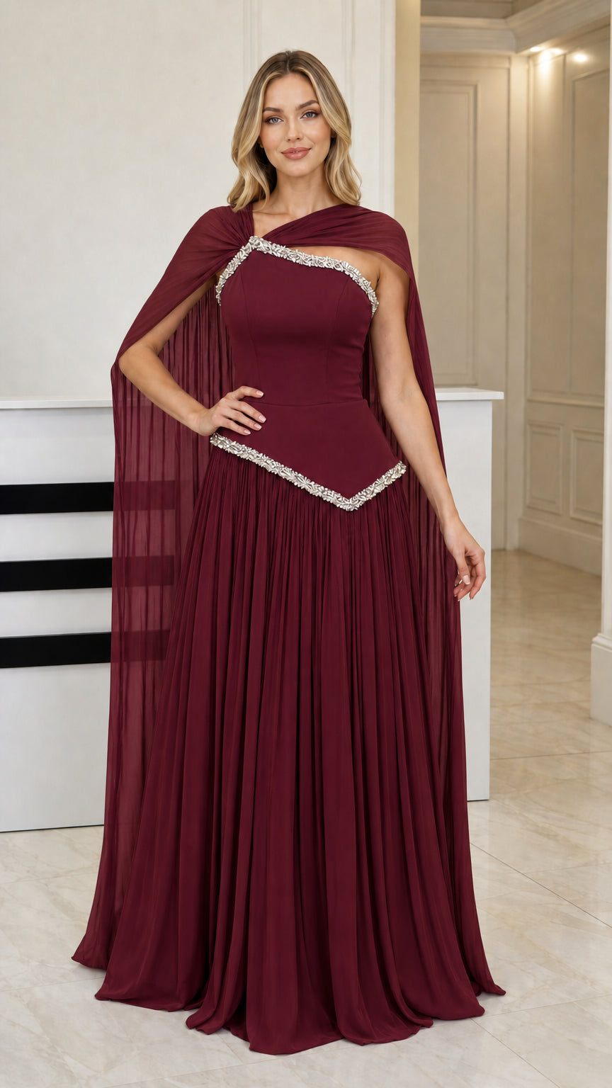 Front view of burgundy red formal cape maxi gown with crystal trim