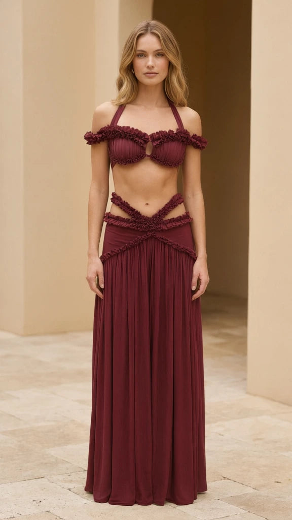 Model wearing burgundy ruffled halter two-piece maxi skirt set