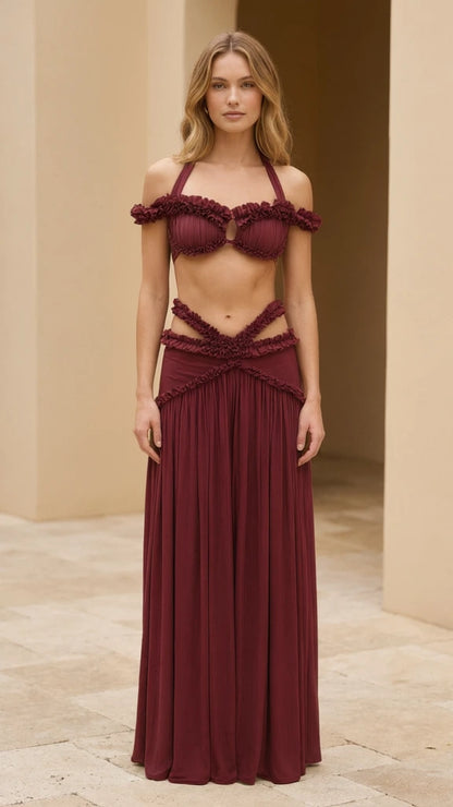Model wearing burgundy ruffled halter two-piece maxi skirt set