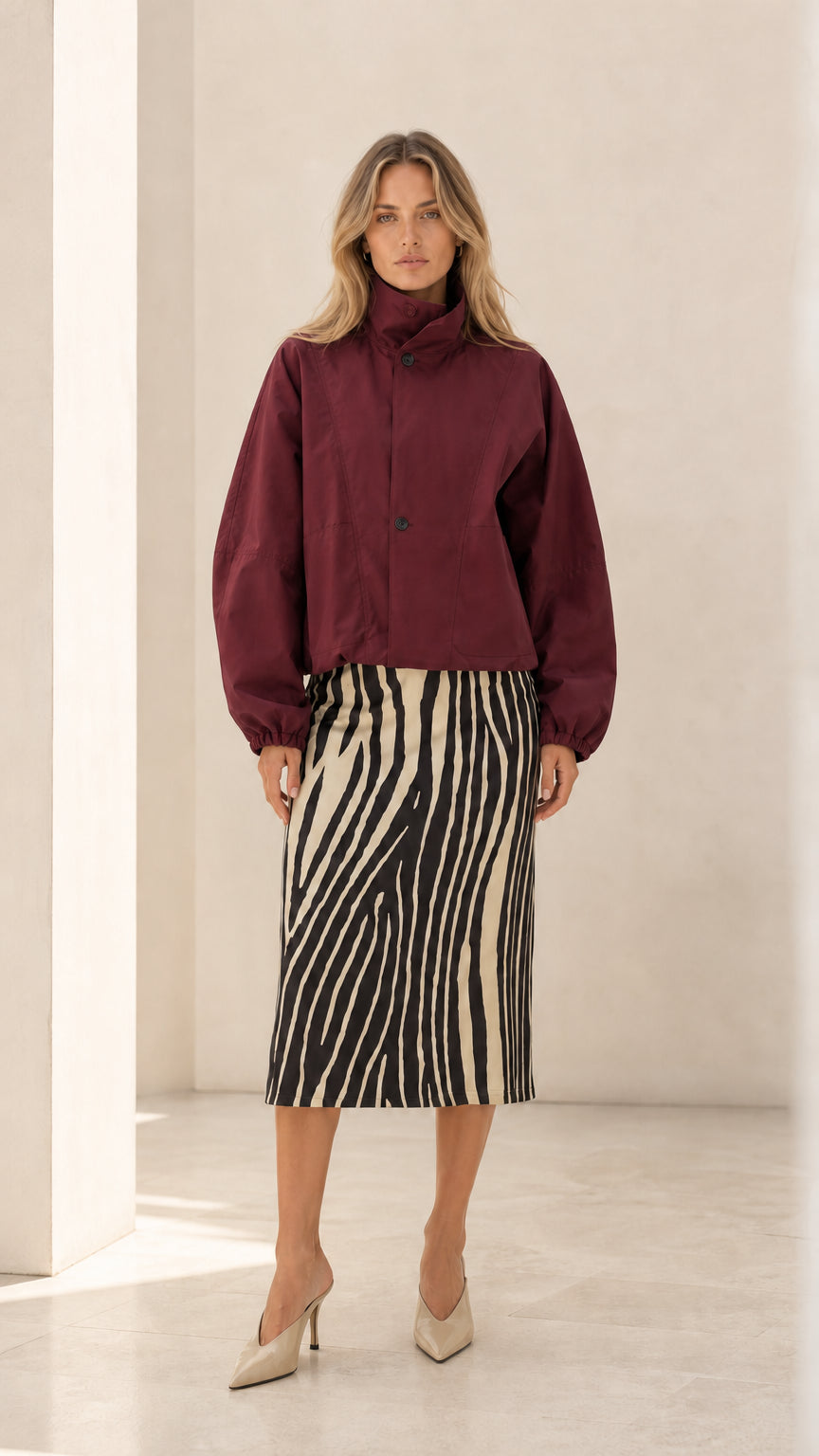 Front view of woman wearing burgundy wine cropped blouson jacket